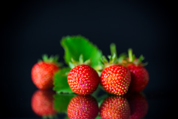 ripe red strawberries on a black background