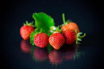 ripe red strawberries on a black background