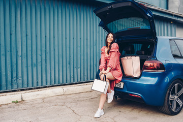 a young girl dressed and dressed sexy that comes from shooping with the packs in hand with a blue...