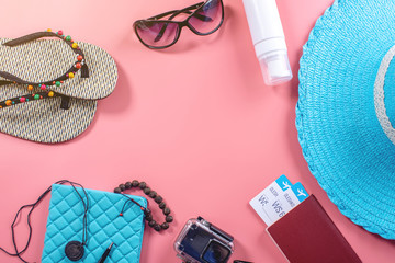 Travel holiday supplies: hat, sunglasses, camera passport and airline tickets on pink background. Top view. Flat lay