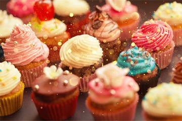 Tasty Colorful cupcakes on background