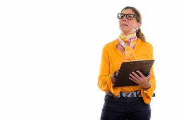 Studio shot of mature beautiful businesswoman holding clipboard 