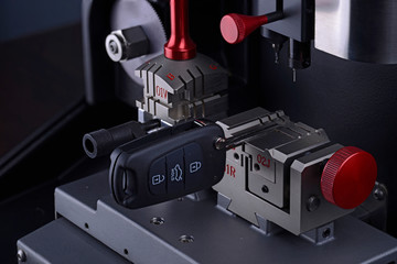 Close view of key copying machine with key. Duplicate machine make new key. Locksmith theme. Blank...