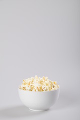 Bowl of popcorn isolated on white background.