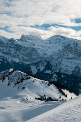 Fototapeta na wymiar A ski resort’s trail captured with mountains as a background