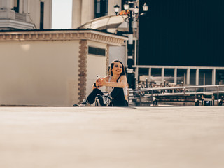 Fit young woman relax after rollerblading in urban city