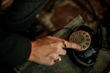 man dialing a retro vintage telephone 