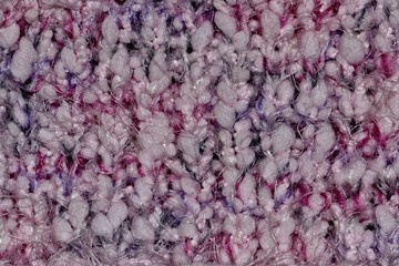 Macro color swatch of a knit hat with several different color woolen threads interwoven in the garment.