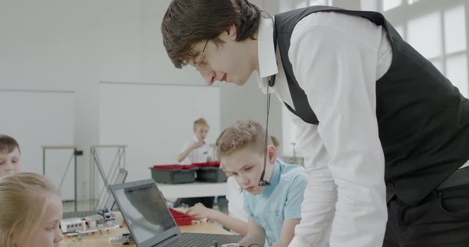 Curious kids working on a functional programable robot during robotics class at school. 4K UHD 60 FPS SLOW MOTION