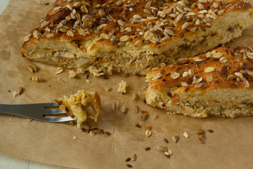 Tasty sliced pie with meat and cheese and grains on top