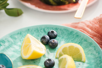 Close-Up of Blueberries and Lemon Slices on Teal Plate