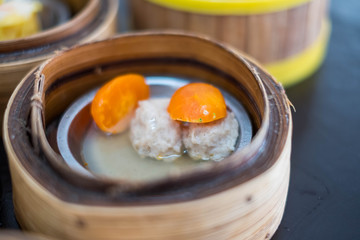 Closeup of Dim Sum in bamboo steamer, Chinese cuisine.
