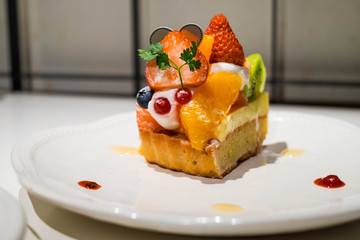 Fruit cheesecake on the white dish.