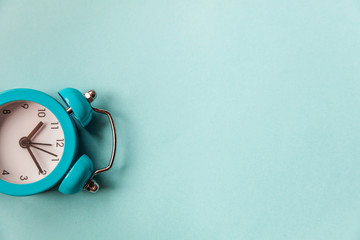 Ringing twin bell vintage classic alarm clock Isolated on blue pastel colorful trendy background....