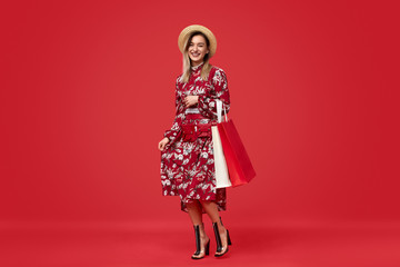 Cheerful woman in floral dress during shopping