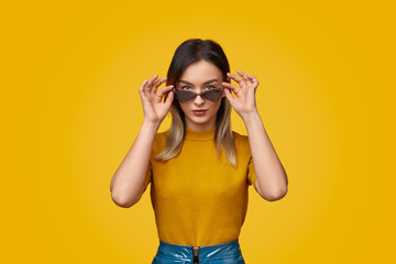 Stylish lady adjusting sunglasses