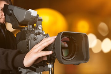 Cameraman with his camera on white background