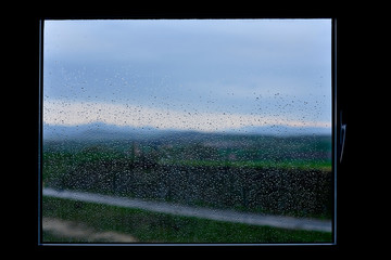 dawn on a rainy spring day behind a window with glass mottled with raindrops, Vitoria-Gasteiz, Alava, Basque Country, Spain