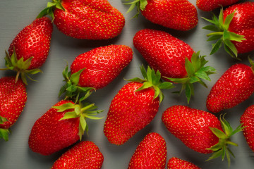 Top view ripe strawberry on a gray wooden background
