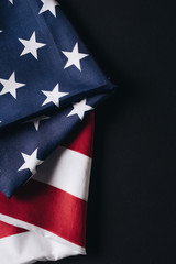 folded united states national flag isolated on black, memorial day concept