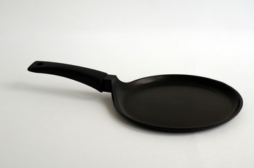 black fry pan over white background