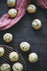 Obraz premium Flat Lay of Mini Blueberry Muffins on Dark Background