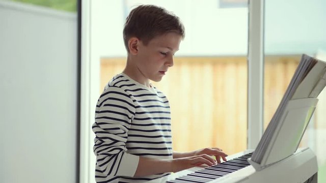 Handsom teenager has pieano lesson