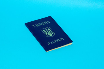 Ukrainian passport on a blue background. Top view