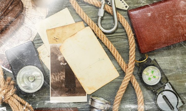 Traveler stuff on wooden table, vintage background