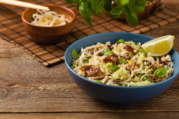 Fried veal, with rice, Chinese cabbage and mushrooms. Sprinkled with sesame and soy sauce.