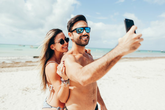 Young couple having fun on tropical beach