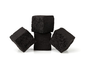Coconut charcoal on a white background. Coconut coal cubes for hookah close-up.