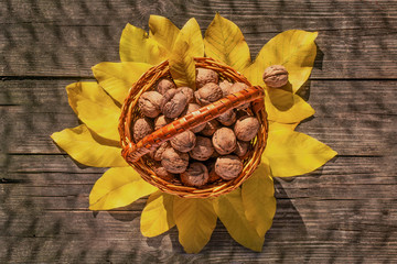 Walnuts in a basket on a wooden background. View from above