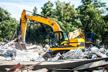 Stones, destroyed buildings, building. Demolition. A pile of stones. Crane