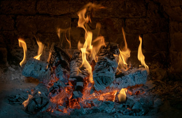 The mesmerizing flames of a beautiful fire in rustic brick ovens.