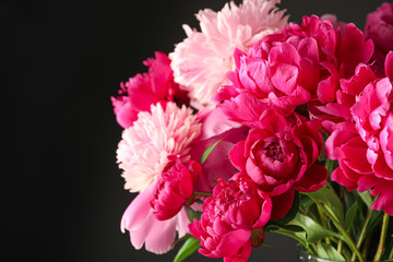 Fototapeta premium Bouquet of beautiful pink peonies against dark background, space for text