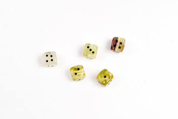 Dices made of natural stone on a white background. Copy space. Gaming.