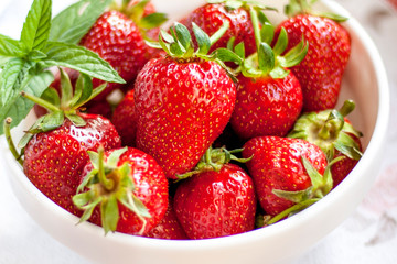 Tasty juicy strawberries on a white plate