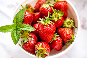 Tasty juicy strawberries on a white plate
