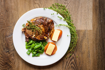 Beef steak with beans cheese on tomatoes on plate
