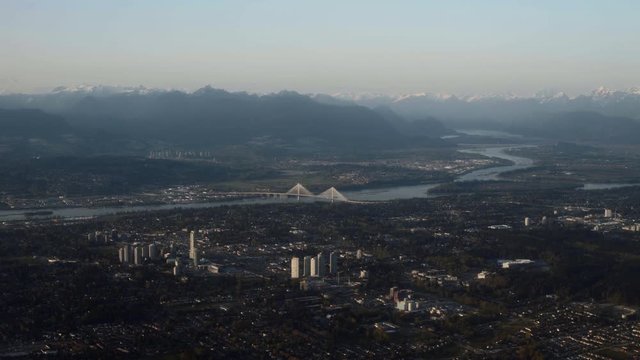 Surrey and Coquitlam in Vancouver, Canada with mountains in background, Aerial shot - Sunset
