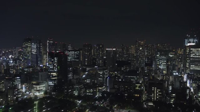 Wide Static Night shot of Minato city skyline in Tokyo, Japan from Tokyo Tower