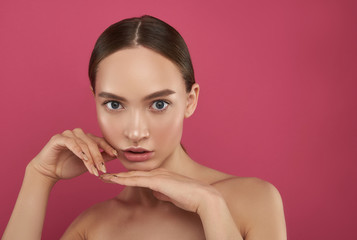 Pretty girl with stylish manicure posing against pink background