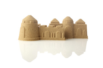 Sandcastle at the beach isolated on white background