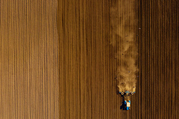 Tractor in field on a farm, aerial view