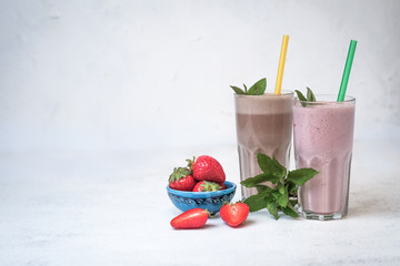 Organic berry and chocolate-nut milkshakes with oatmeal on a light background. Healthy food. Lactose free diet.
