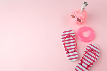 woman's beach flip-flops on the light pastel pink background. beach summer concept and holiday...