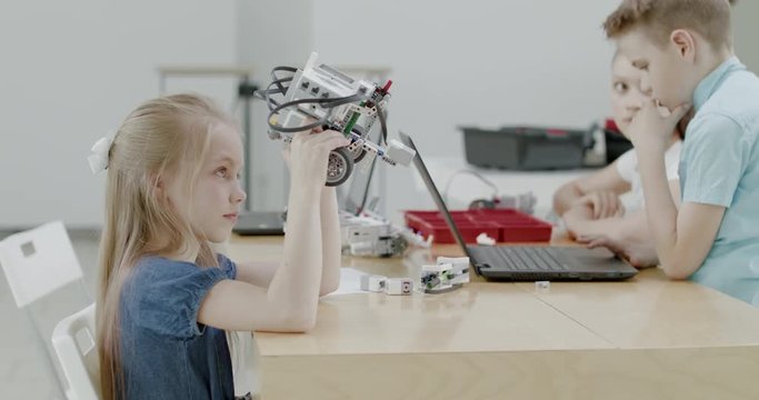 Curious kids working on a functional programable robot during robotics class at school. 4K UHD 60 FPS SLOW MOTION