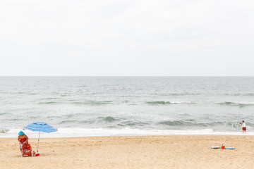 Fototapeta na wymiar Woman Setting Up For Day At The Beach