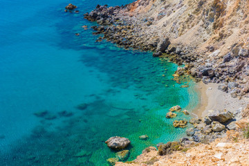 A small secluded sandy beach near sulfur mines (Thiorihia) in Milos island, Cyclades, Greece